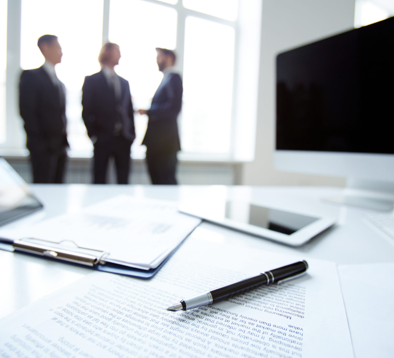 Business devices and documents at workplace, unrecognized businesspeople sharing ideas on background